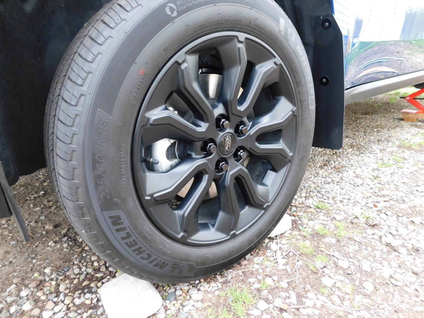 Ford Maverick I replaced the two piece stock lug nuts with one piece black lug nuts. after close.JPG