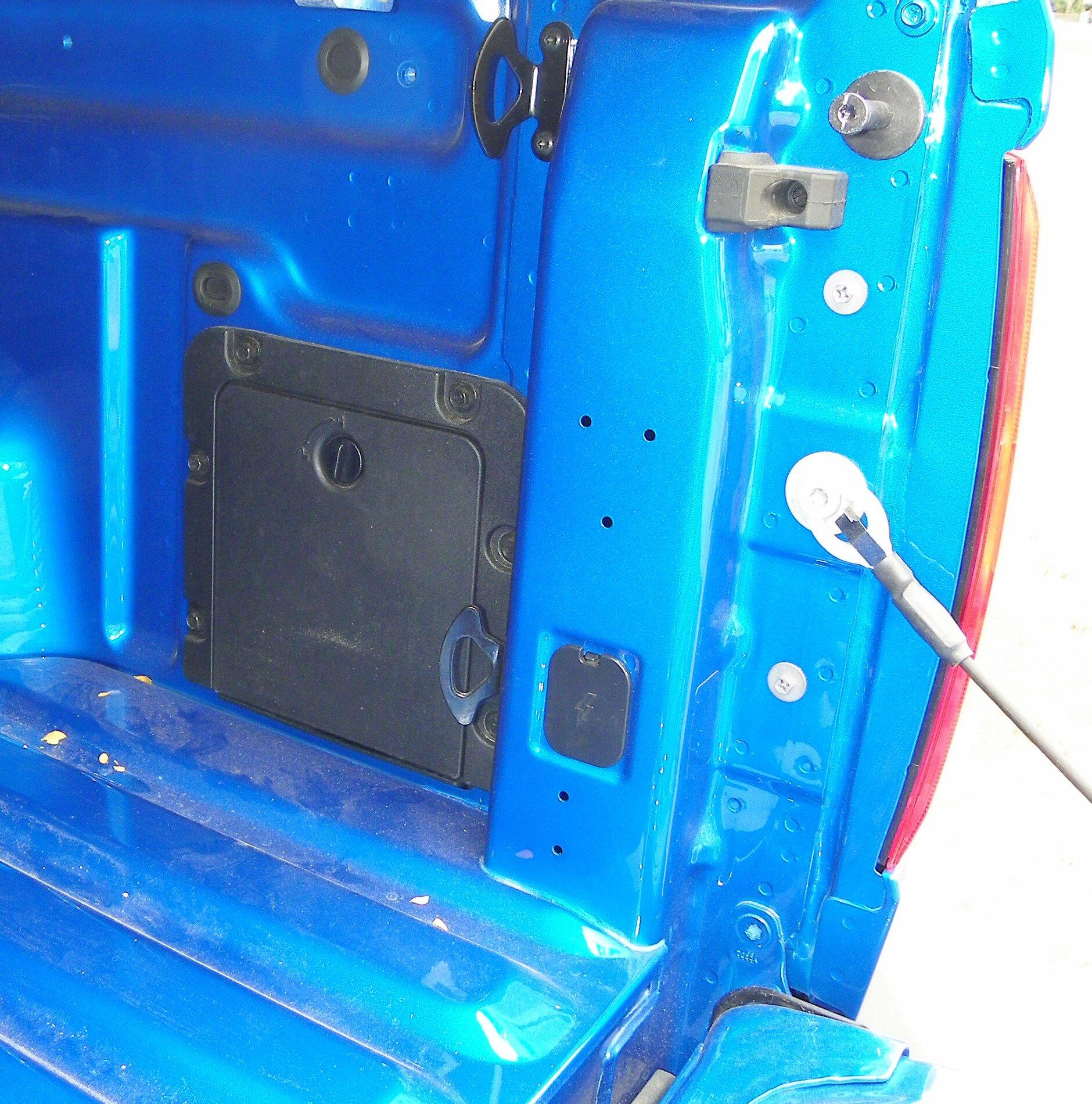 Ford Maverick TX State Fair Auto Show Right side cubby and 12 Volt plug hole.JPG