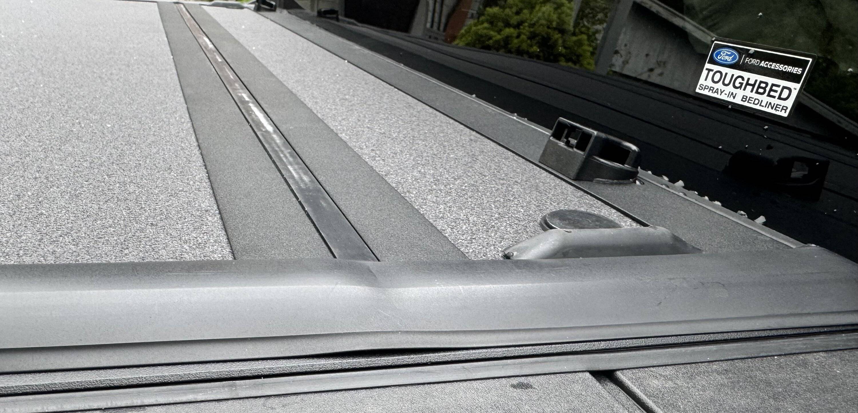 Ford Maverick Newly Ford installed tri-fold rail Tonneau bed cover with weather seal sitting way proud of the surface below, at two cover folds 5_Ford_Maverick_2024_hard_tri-fold-Tonneau_bed cover_right_side_near_cab
