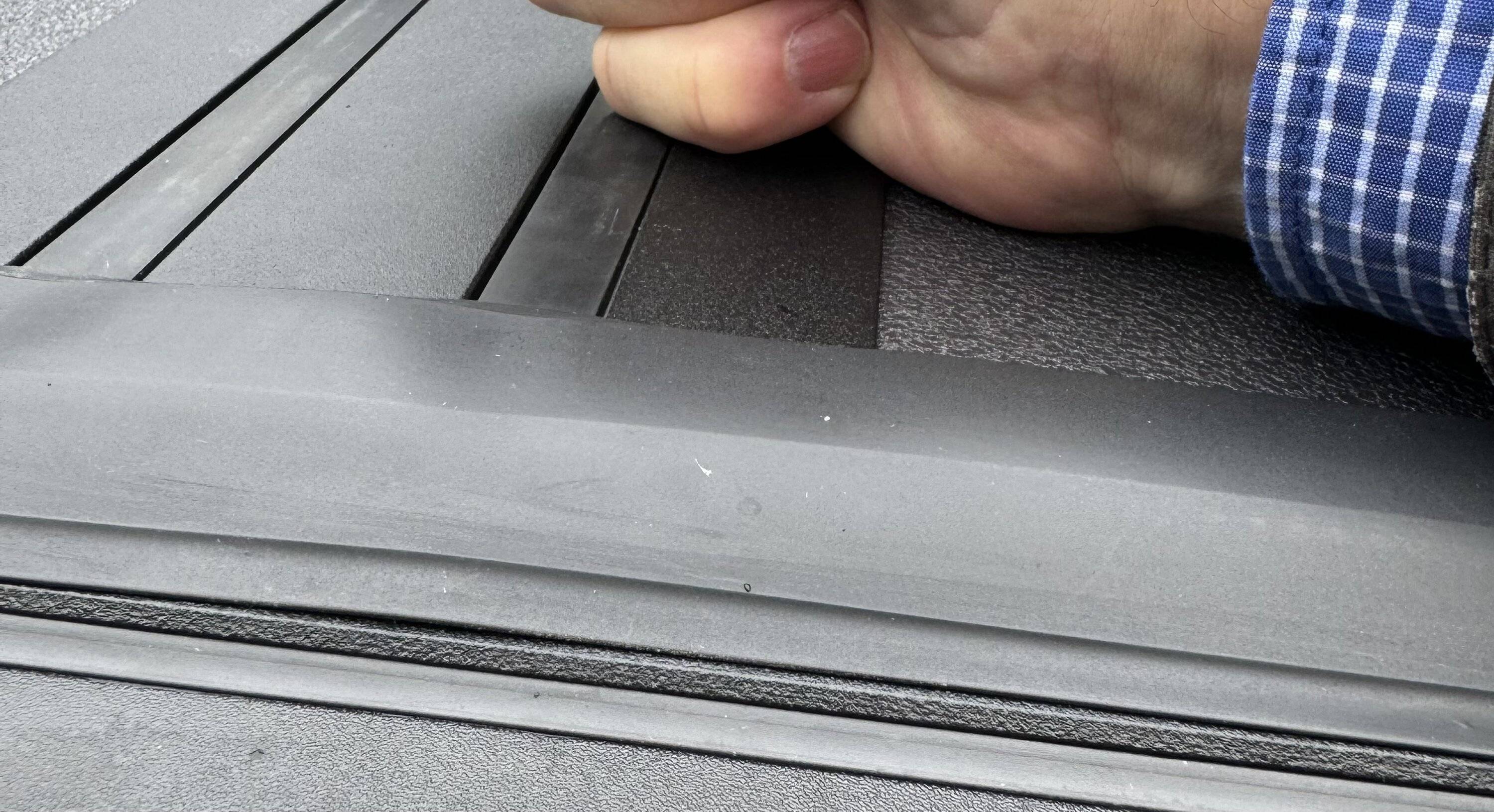 Ford Maverick Newly Ford installed tri-fold rail Tonneau bed cover with weather seal sitting way proud of the surface below, at two cover folds 6_Ford_Maverick_2024_hard_tri-fold-Tonneau_bed cover_right_side_after_pressing_down