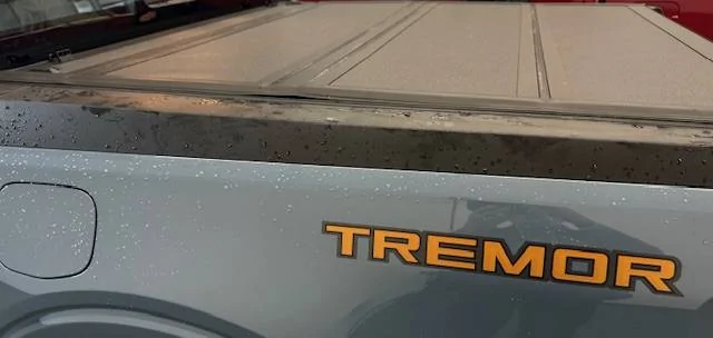 Ford Maverick Newly Ford installed tri-fold rail Tonneau bed cover with weather seal sitting way proud of the surface below, at two cover folds 7_Ford_Maverick_2024_hard__tri-fold-Tonneau_bed cover_left_side_full