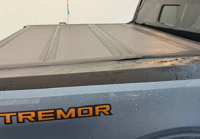 Ford Maverick Newly Ford installed tri-fold rail Tonneau bed cover with weather seal sitting way proud of the surface below, at two cover folds 8_Ford_Maverick_2024_hard__tri-fold-Tonneau_bed cover_right_side_full