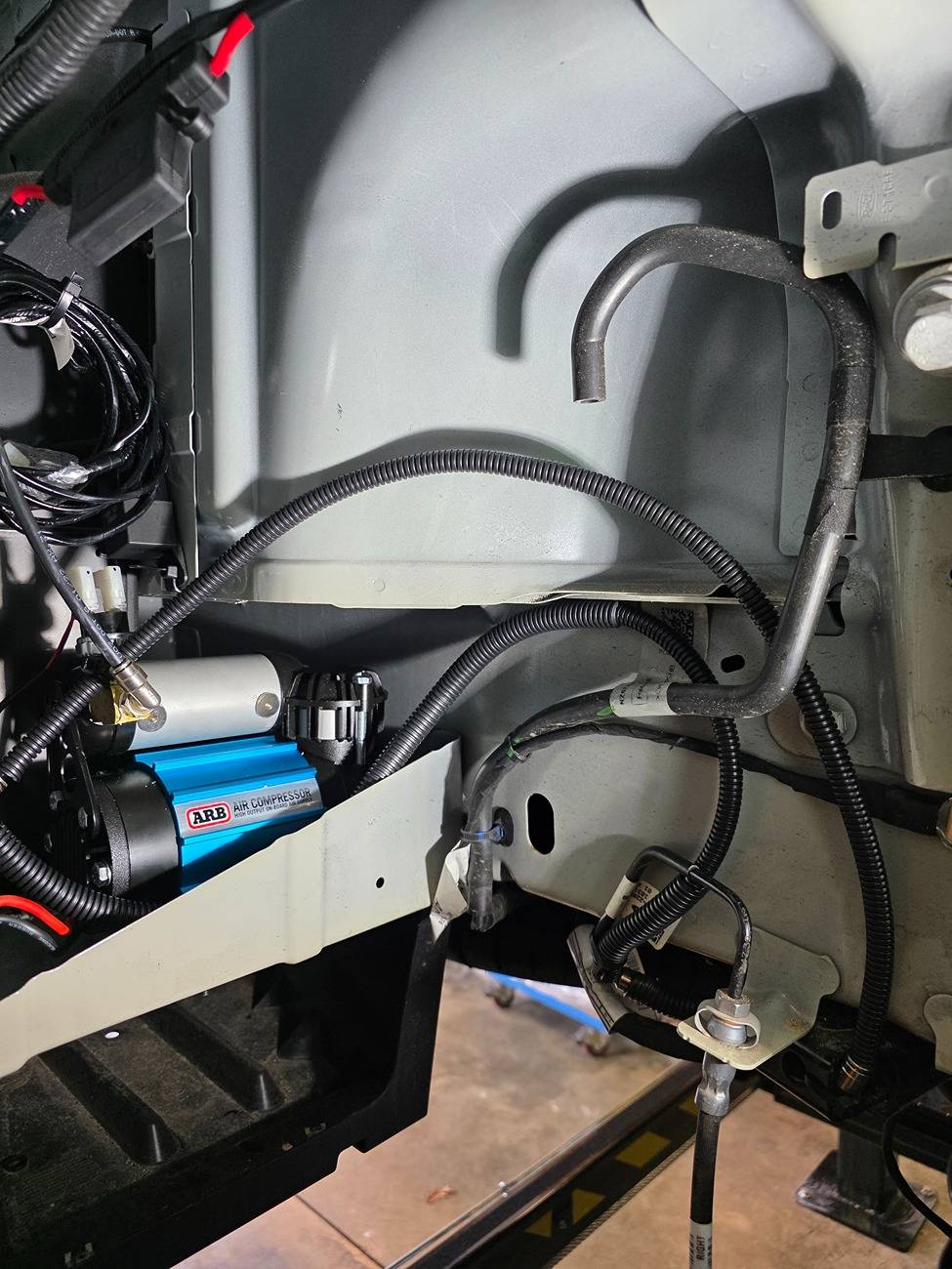 Ford Maverick 2025 AWD hybrid Maverick - air bag suspension and compressor(s) install. compressor mounting in fender
