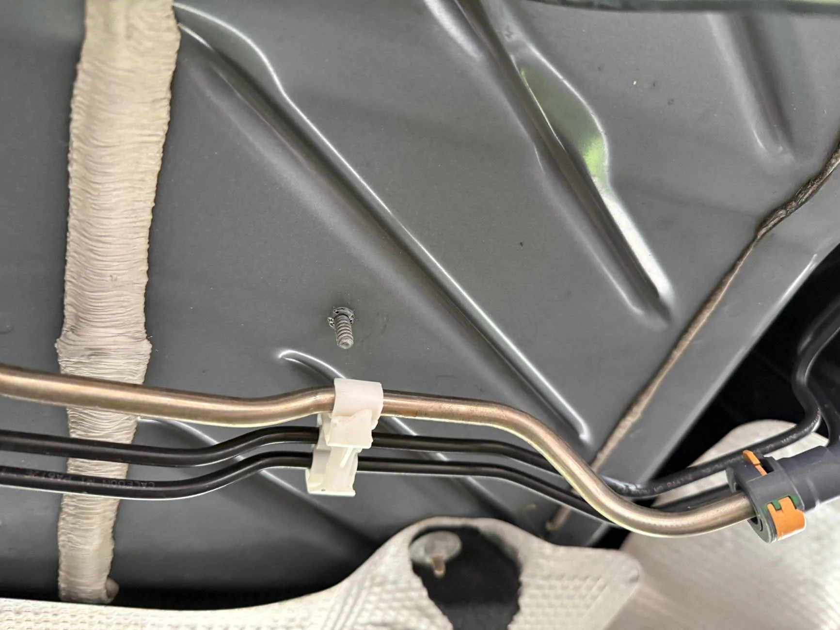 Ford Maverick Fluid line clip on underside forward of fuel tank IMG_4929