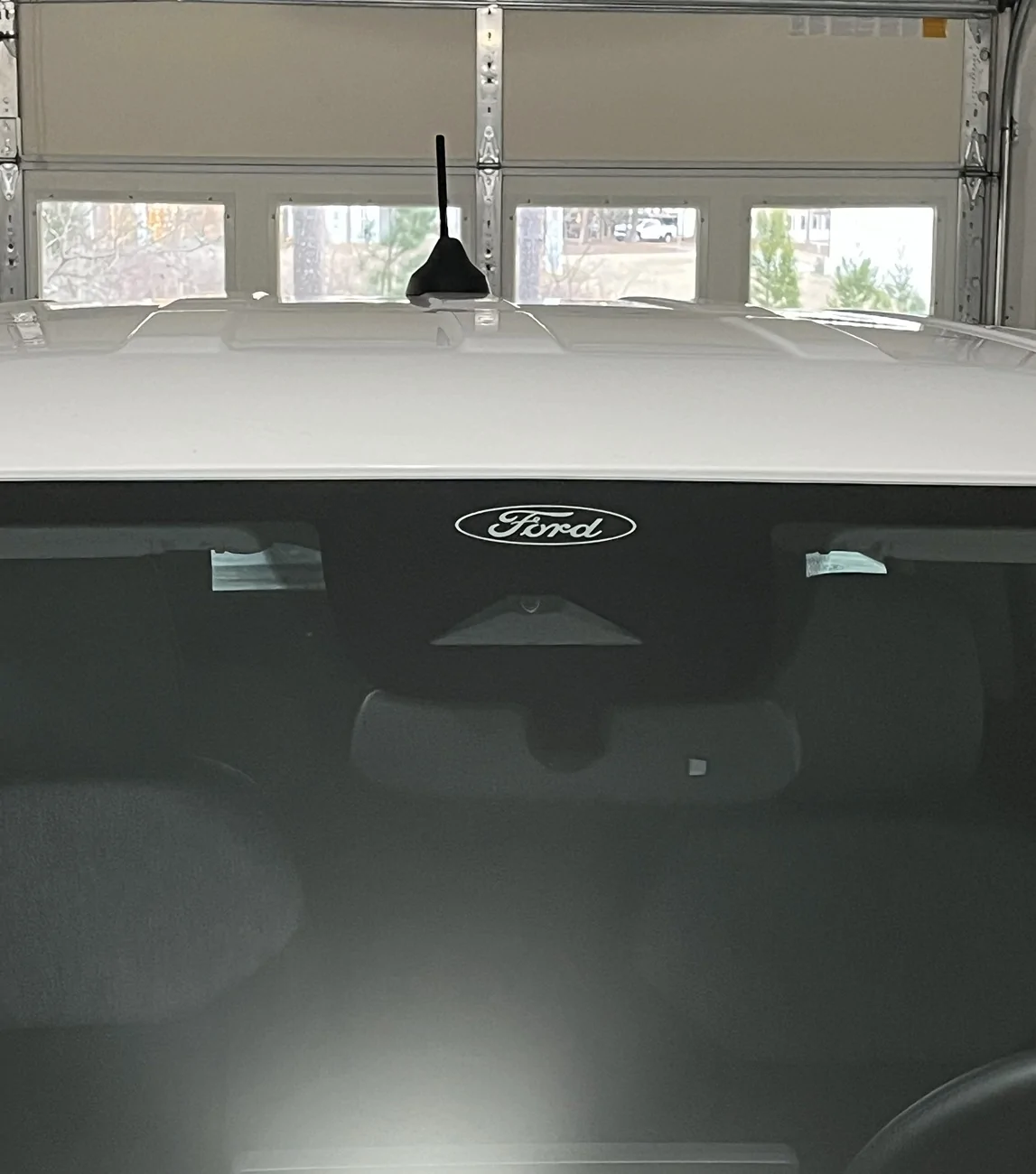 Ford Maverick Ford logo above front windshield camera and safety sensor? 2026 ford logo