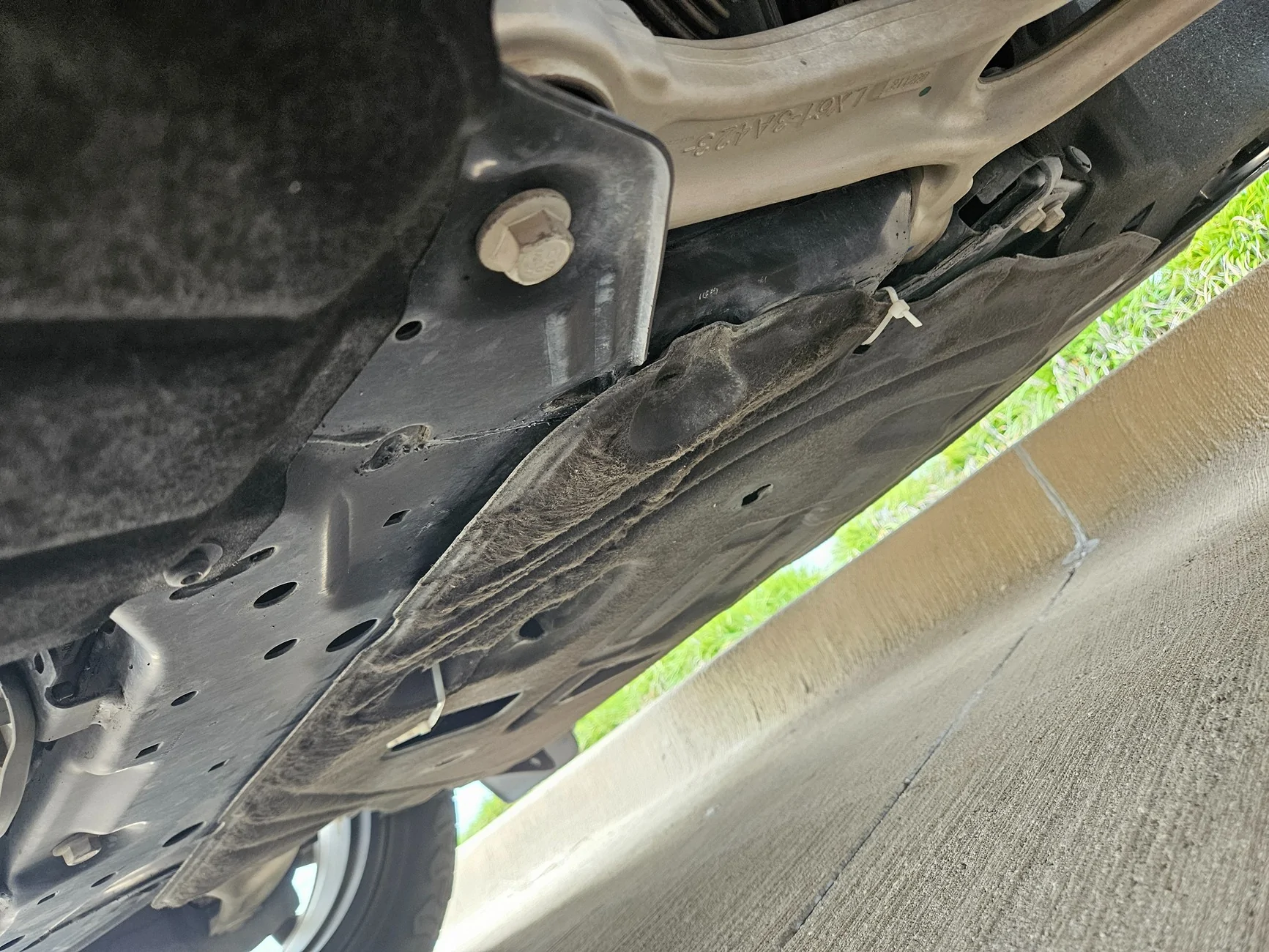 Ford Maverick Loose splash shield flapping and dragging after oil change. 1000003535