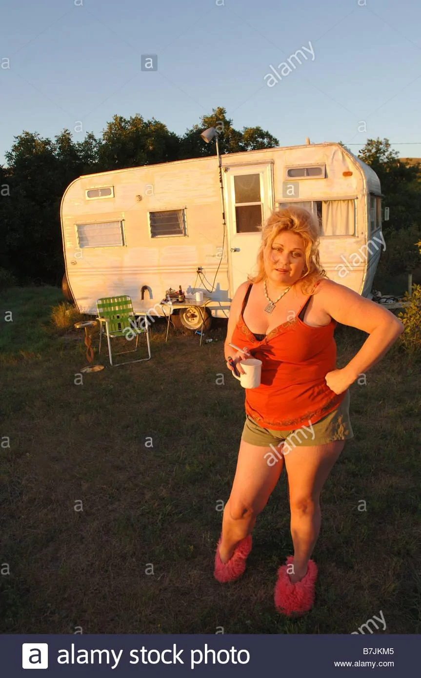 woman-in-slippers-beside-run-down-trailer-canada-saskatchewan-cypress-B7JKM5.jpg