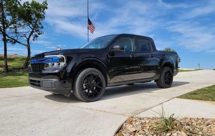 Customized headlights, taillights, emblems, grille, and wheels are on
