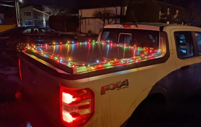 Outlet in bed powering holiday cheer (Christmas lights)