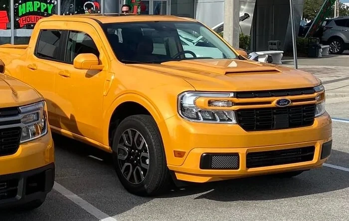 Painted grill bar, bumpers, fender vents, hood scoop - matched to body color on Maverick (Cyber Orange)