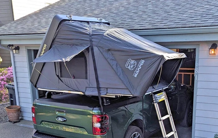 RTT iKamper roof top tent with Thule Aerobars over a BAK Revolver X4S with tracks.