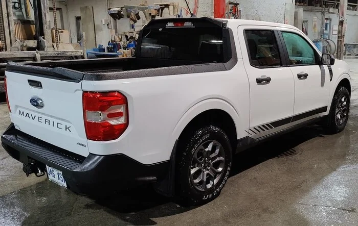 White Maverick looking good with cab spoiler, mudflaps, tailgate spoiler, hood protector, stripes, tires