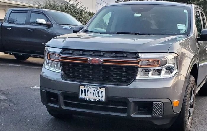 Added some color to gray Maverick w/ orange grill accent bar, Ford emblem and tailgate letters