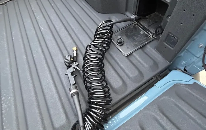 Stealth onboard air compressor install in bed.