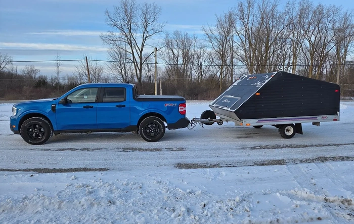 Maverick tows Clamshell Sled Trailer easily