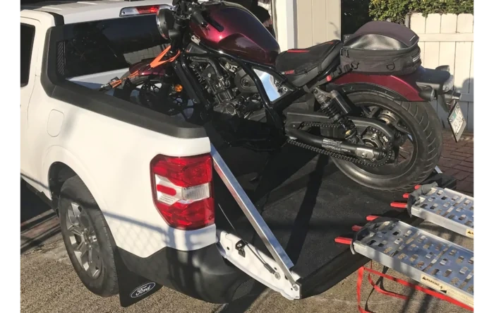 My real truck can haul my motorcycles w/ help of custom metal tailgate support and level struts
